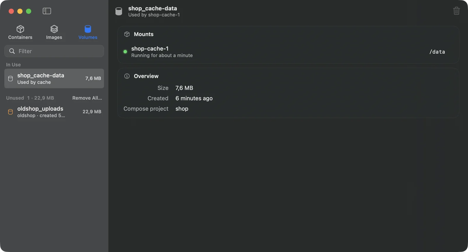 The Volumes tab: a volume in use by the cache container, mounted at /data, and an unused volume left by an old Compose project